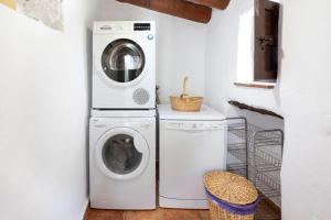 a laundry room with two washing machines and a washer and dryer at Cortijo Salva in Periana