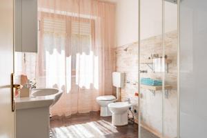 a bathroom with a white toilet and a sink at Villa Le Maree di Tonfano in Pietrasanta +21 photos