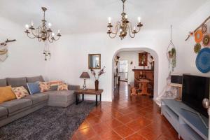 a living room with a couch and a tv at Casa Terracota in Silves