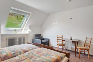 a bedroom with a bed and a table and chairs at Bergbauernhof 1910 in Oberharmersbach