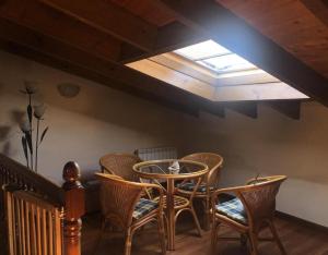 a dining room with a table and chairs and a skylight at Juderia I in Oña