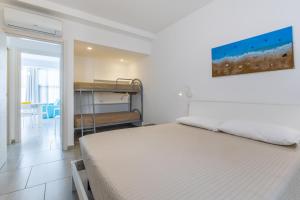 a bedroom with a bed and a room with a table at Villa Vani - Appartamento 2 in Marina di Ragusa +15 photos