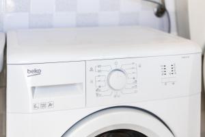 a white washer and dryer in a bathroom at Villa Vani - Appartamento 2 in Marina di Ragusa