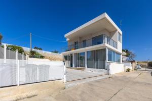 a large white house with a lot of windows at Villa Vani - Appartamento 2 in Marina di Ragusa