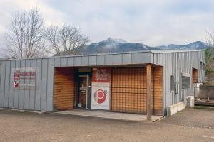 a building with a door open in front of it at Appart bureau in Le Touvet