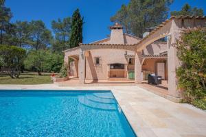 a house with a swimming pool and a gazebo at Maison - La Lieutenante in Puget-sur-Argens
