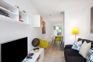 a living room with a couch and a flat screen tv at Ferienhaus Schwalbennest in Lörrach