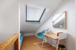 a room with a desk and chairs in a attic at Ferienhaus Schwalbennest in Lörrach