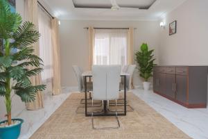a dining room with a table and chairs at Tanga New Apartments in Tanga +13 photos
