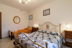 a bedroom with a bed and a dresser and a mirror at Papà Giuseppe La Cantina in Cortona +17 photos