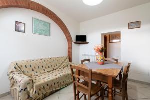 a living room with a couch and a table at Papà Giuseppe La Cantina in Cortona
