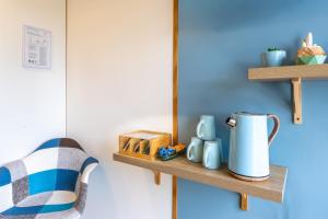 a shelf with a jug and cups on a wall at Chambres d'hôtes Le Boiziller in Saint-Michel-Mont-Mercure