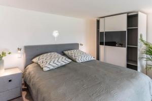 a bedroom with a bed with two pillows on it at Ferienwohnung Schweizer in Gaienhofen
