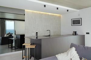 a kitchen and living room with a sink and a couch at Suite Horizonte in Puerto del Carmen +15 photos
