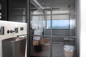 a bathroom with a glass wall with a sink at Suite Horizonte in Puerto del Carmen