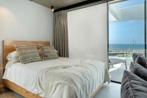 a bedroom with a bed with a view of the ocean at Suite Horizonte in Puerto del Carmen