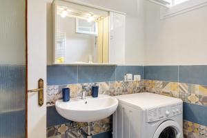 a bathroom with a sink and a washing machine at Ca Giannina in Bonassola +19 photos