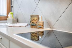 two candles are sitting on a counter in a bathroom at Haus zur Vogelweide App 6 in Dobbiaco +22 photos