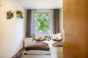 a bedroom with a bed with a stuffed animal on it at Ferienwohnung am Elbstrom in Stade