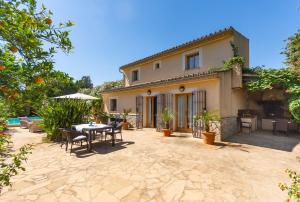 a patio of a house with a table and chairs at Finca Son Fornes in Búger