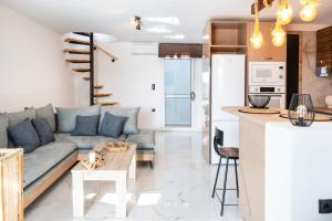 a living room and kitchen with a couch and a table at Mont' Rock villas 1 in Posidhonía