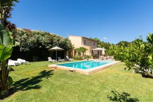 a swimming pool in the yard of a house at Finca Son Fornes in Búger