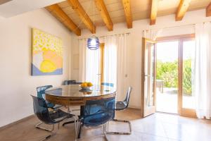 a dining room with a table and chairs at Finca Son Fornes in Búger