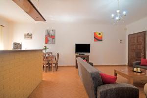 a living room with a couch and chairs and a table at Kallithea House in Corfu