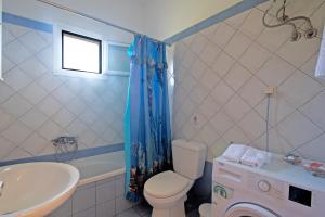a bathroom with a toilet and a sink and a tub at Kallithea House in Corfu +18 photos