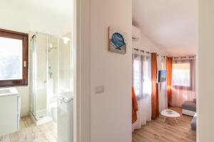 a bathroom with a shower and a sink and a toilet at Villa Aloe 2 in Costa Paradiso
