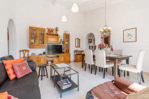 a living room with a couch and a dining room at Villa Villena Torrox in Torrox