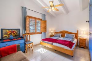 a bedroom with a bed and a couch and a window at Villa Villena Torrox in Torrox +25 photos