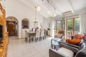 a living room with a couch and a table at Villa Villena Torrox in Torrox