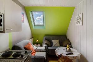a small living room with a couch and a window at Ferienhaus Gerda Wohnung 2 in Westochtersum