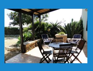 a patio with a table and chairs on a patio at Isola Di Favignana in Favignana
