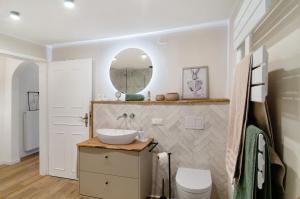 a bathroom with a sink and a mirror at Ferienwohnung Seelenruhig in Wollershausen +32 photos