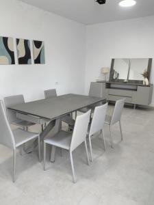 a dining room with a table and chairs at Quiet house with garden in Sakiet ez Zit