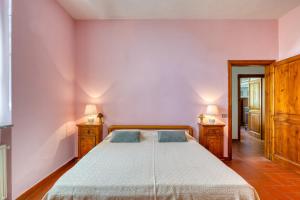 a bedroom with a large bed with two night stands at Appartamento Villa Marta in Spoleto