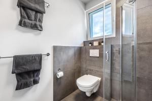 a bathroom with a toilet and a glass shower at Egge Resort 7d mit Whirpool u Sauna in Altenbeken +17 photos