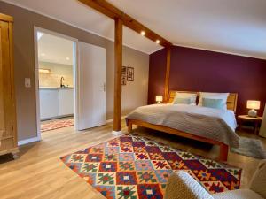 a bedroom with a bed and a colorful rug at Ferienwohnung an der Schlei oben in Fleckeby