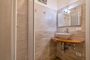 a bathroom with a sink and a mirror at Holiday Cala Sant'andrea in Stintino +18 photos