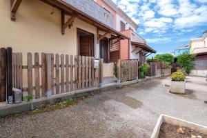a wooden fence in front of a house at Holiday Cala Sant'andrea in Stintino