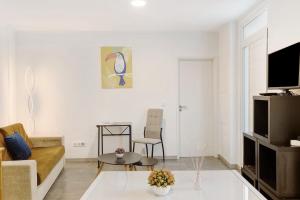a living room with a couch and a table at Funchal House in Funchal