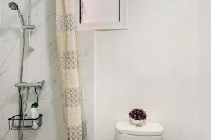 a bathroom with a toilet and a window at Funchal House in Funchal +13 photos
