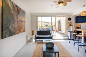 a living room with a couch and a table at Appartement Notre Dame in Capbreton