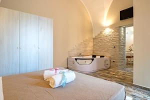 a bedroom with a bed and a bath tub at Sg Apartment Luxury in Massafra