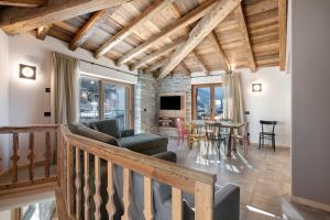 a living room with a couch and a table at Casa Ronden Mortirolo in Mazzo di Valtellina