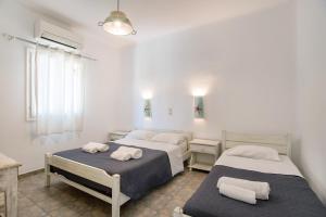 a bedroom with two beds with towels on them at Green Retreats 1 Paros in Isterni