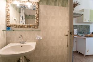 a bathroom with a sink and a mirror at Green Retreats 1 Paros in Isterni