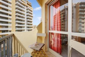 a balcony with a chair and some buildings at Casa Farol in Portimão